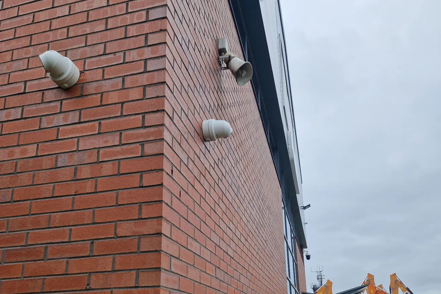 External CCTV cameras protecting a commercial brick building